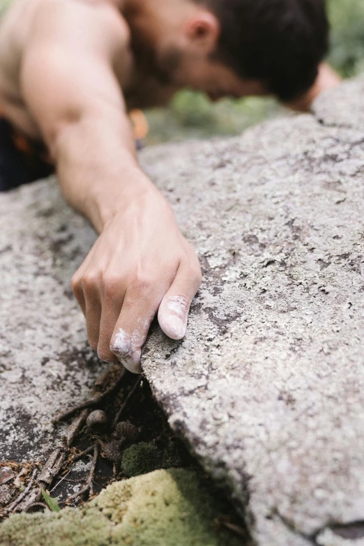 a close up of a person climbing on a rock