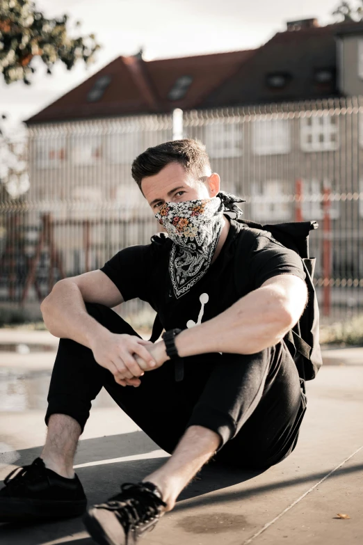 a man sitting on a skateboard wearing a face mask, inspired by Hedi Xandt, trending on pexels, bandana, discord profile picture, berlin fashion, kaleidoscopic