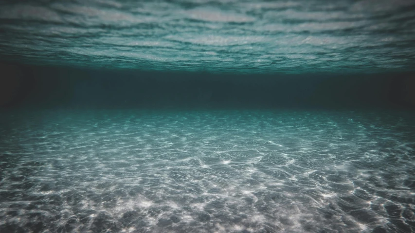an underwater view of the ocean floor, a picture, unsplash contest winner, maybe small waves, slightly tanned, ambient teal light, unsplash 4k