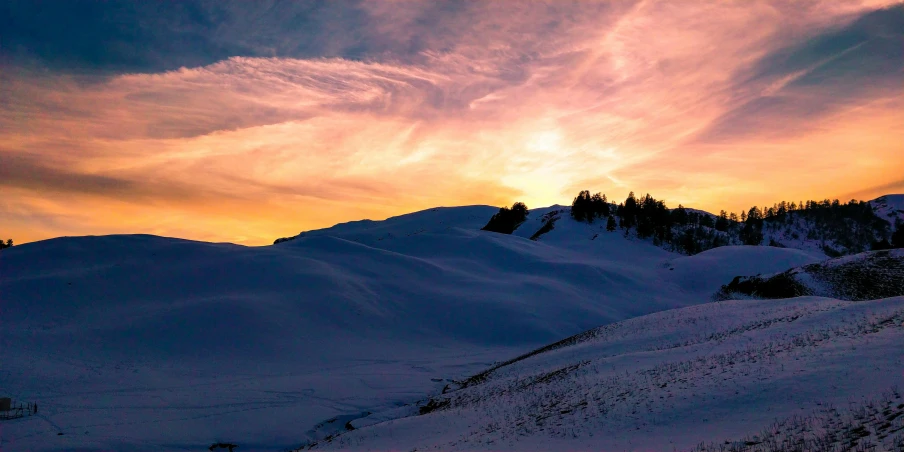 a person riding skis down a snow covered slope, les nabis, the colours of the sunset, dessert, set photo