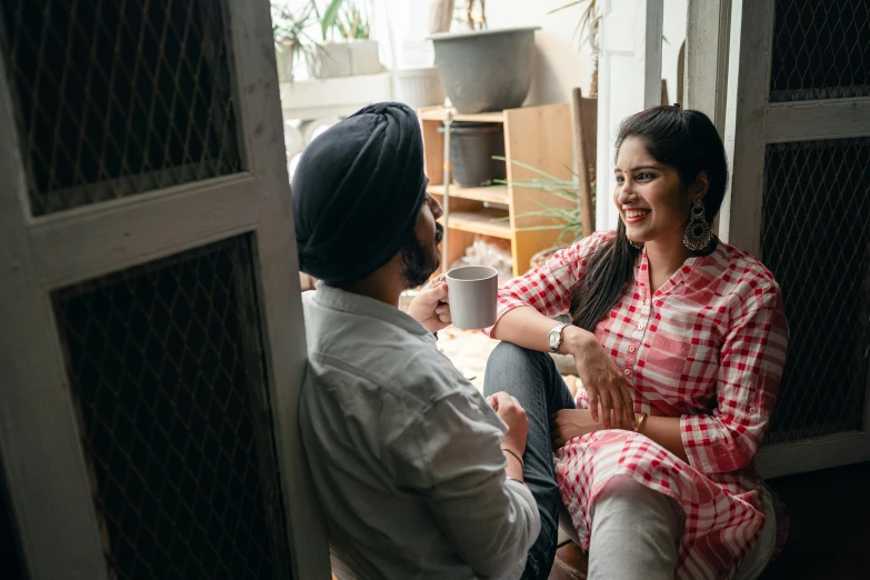 a man and a woman sitting next to each other, inspired by Manjit Bawa, pexels contest winner, hurufiyya, morning coffee, looking around a corner, smiling couple, south east asian with long