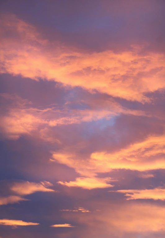 there is a plane that is flying in the sky, by Linda Sutton, flickr, romanticism, orange / pink sky, major arcana sky, cloud and sky color scheme, soft purple glow