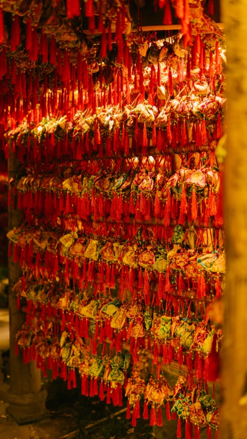 a bunch of red tags hanging from a tree, inspired by Ai Weiwei, pexels, golden treasures on the walls, nighttime, square, chinese costume