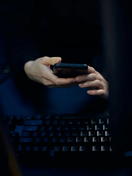 a close up of a person using a cell phone, a picture, computer art, /r/razer, non-binary, dark photo, dark. no text