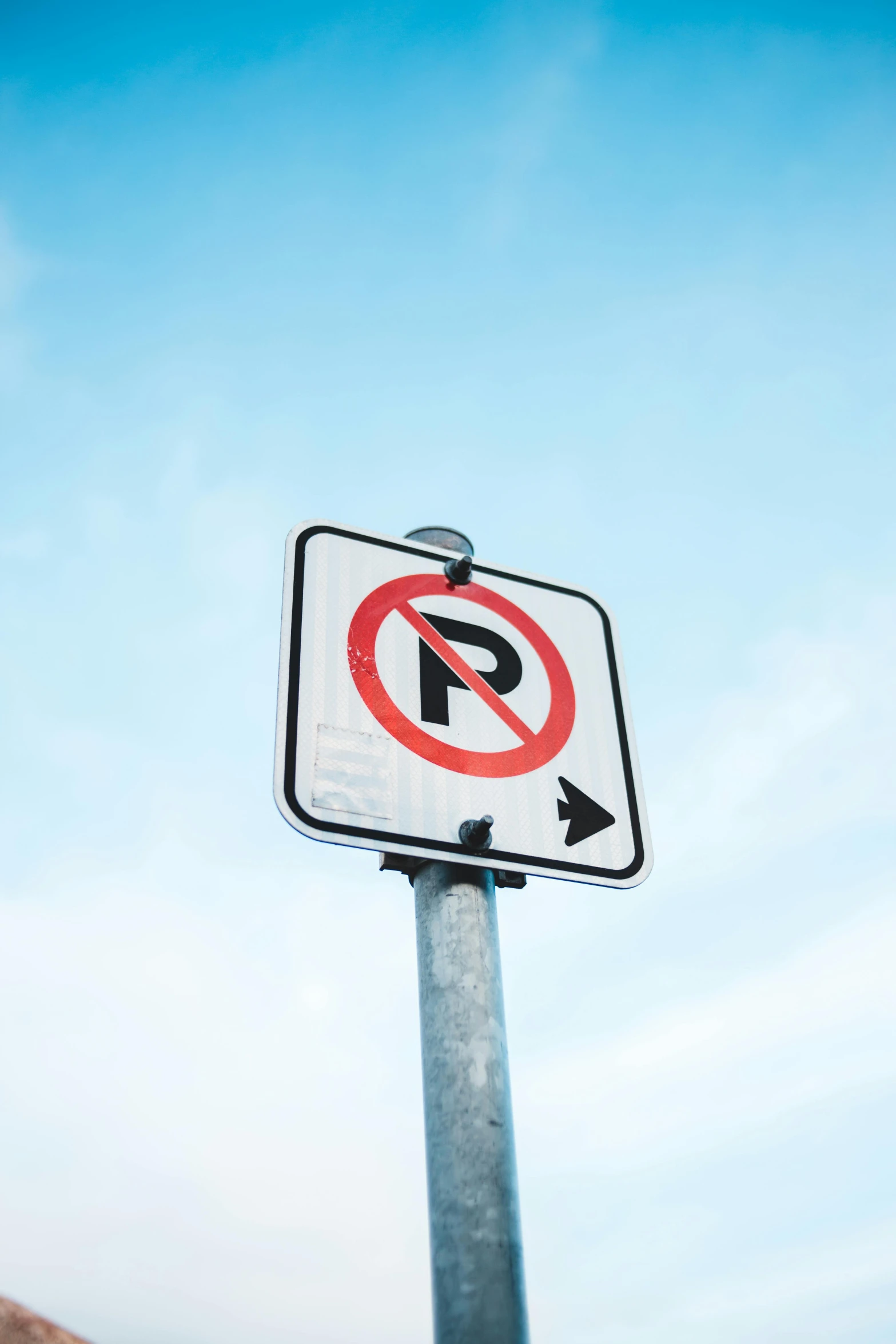 a no parking sign in front of a blue sky, by Ryan Pancoast, pexels, square, high-key, intersection, —n 9