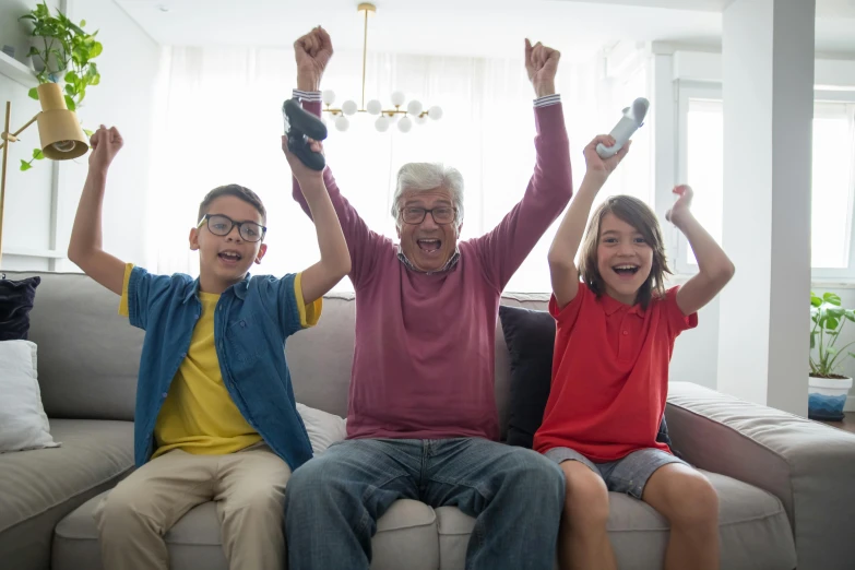 a couple of kids sitting on top of a couch, pexels contest winner, happening, old lady screaming and laughing, nintendo game, grandfatherly, showing victory