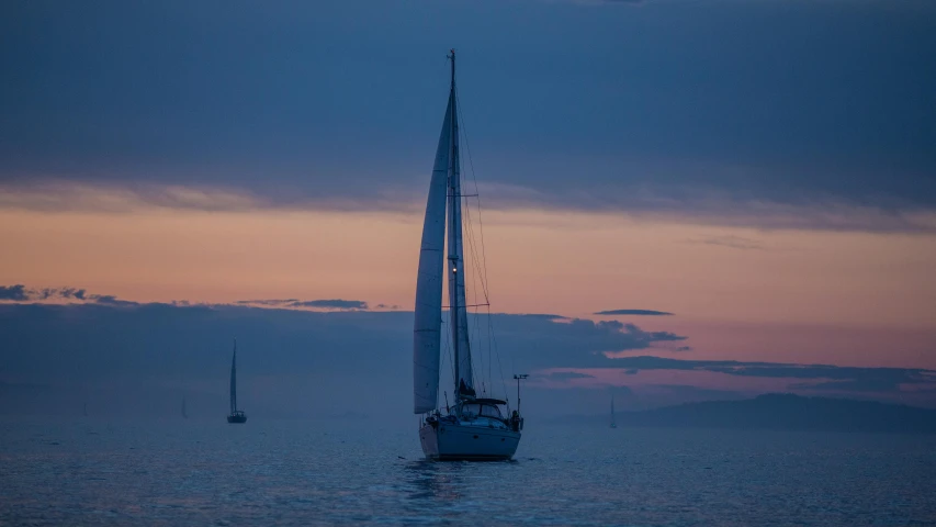 a sailboat in the middle of the ocean at sunset, by Joseph Severn, pexels contest winner, romanticism, sideview, night time, abel tasman, grey