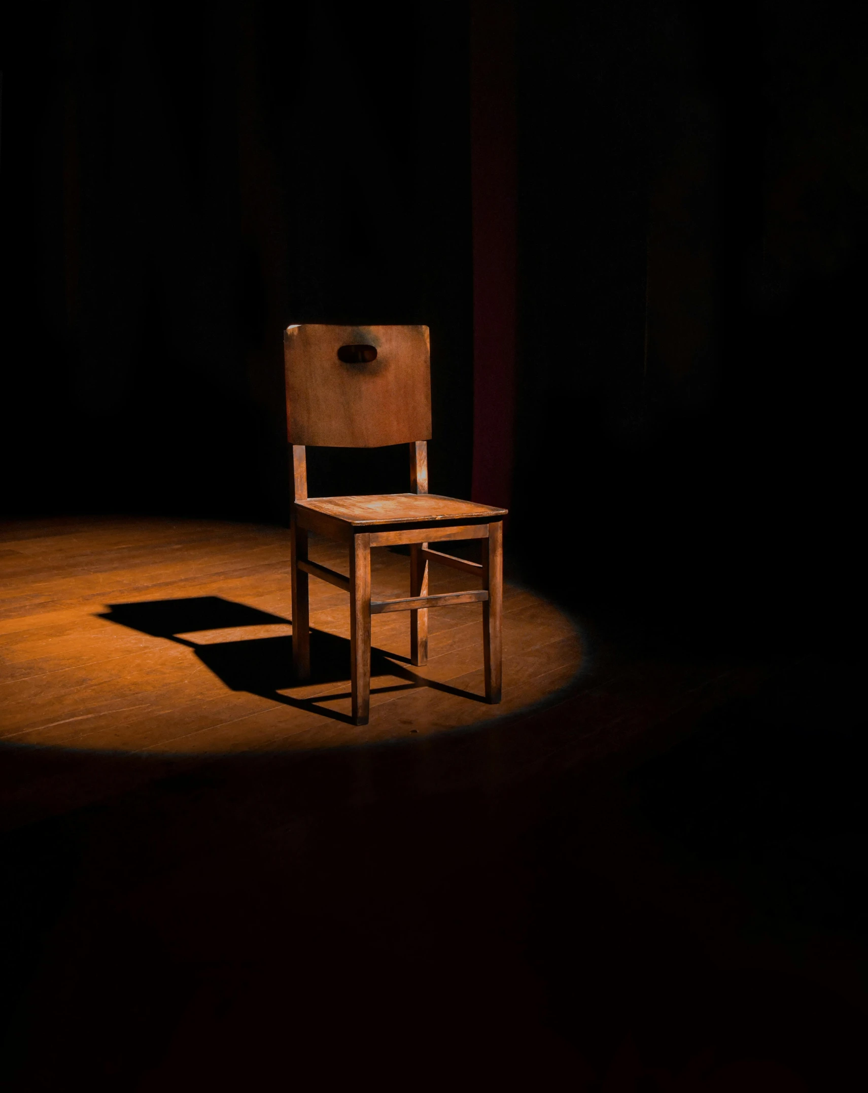 a wooden chair sitting on top of a wooden floor, by Jesper Knudsen, pexels contest winner, stage light, ( ( theatrical ) ), a seance, ignant