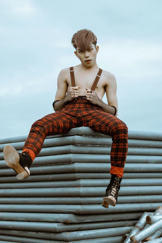 a man sitting on top of a pile of pipes, trending on pexels, attractive androgynous humanoid, in style of lam manh, suspenders, 1 6 years old