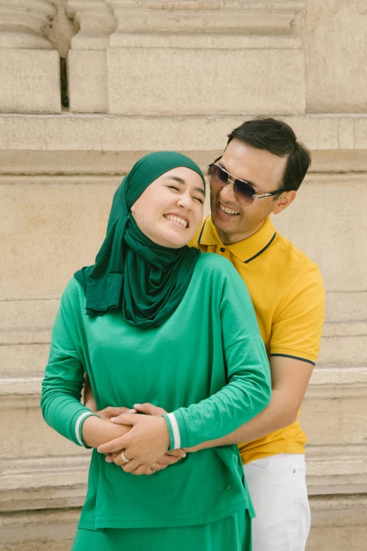 a man and a woman standing next to each other, inspired by JoWOnder, hurufiyya, yellow and green scheme, vacation photo, arm around her neck, mohamed chahin