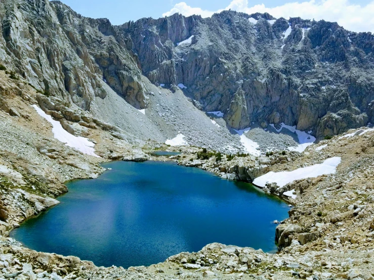 a large body of water surrounded by mountains, by Whitney Sherman, pexels contest winner, mountain lake in sierra nevada, blue water, instagram post, high elevation