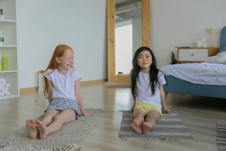 two little girls sitting on a rug in a room, pexels contest winner, marjaryasana and bitilasana, headspace, animation, candid