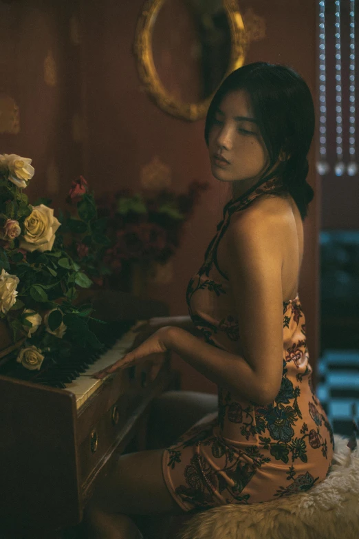 a woman sitting at a piano in a room, inspired by Elsa Bleda, unsplash contest winner, art nouveau, cheongsam, roses in cinematic light, bae suzy, cinematic outfit photo