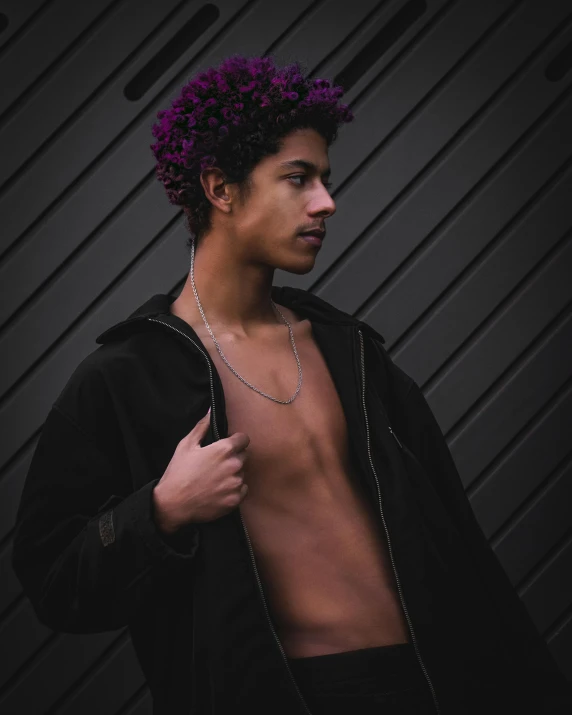 a man with purple hair standing in front of a wall, a colorized photo, by Cosmo Alexander, trending on pexels, (dark shorter curly hair), shirtless :: high detail, black teenage boy, bralette