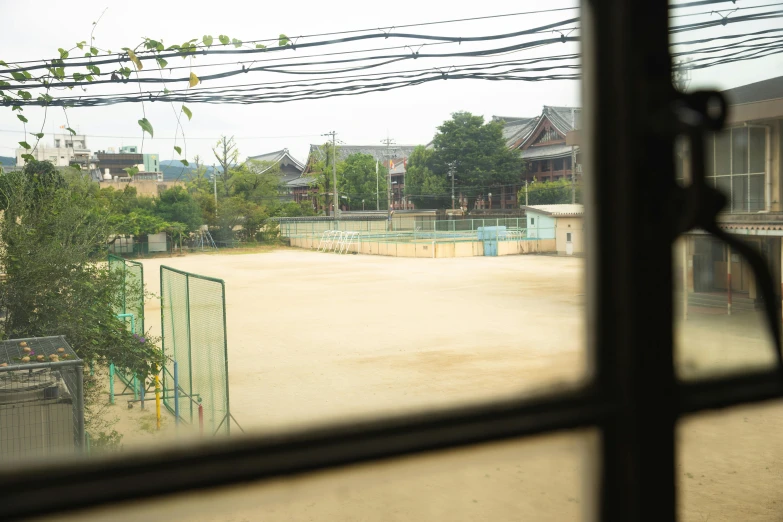 a view of a tennis court through a window, a picture, by Aguri Uchida, unsplash, shin hanga, traditional korean city, school courtyard, dusty ground, pentagon