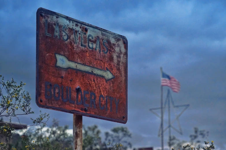 a rusted sign with an american flag in the background, by Dan Luvisi, unsplash, sin city, background image, gopro photo, square