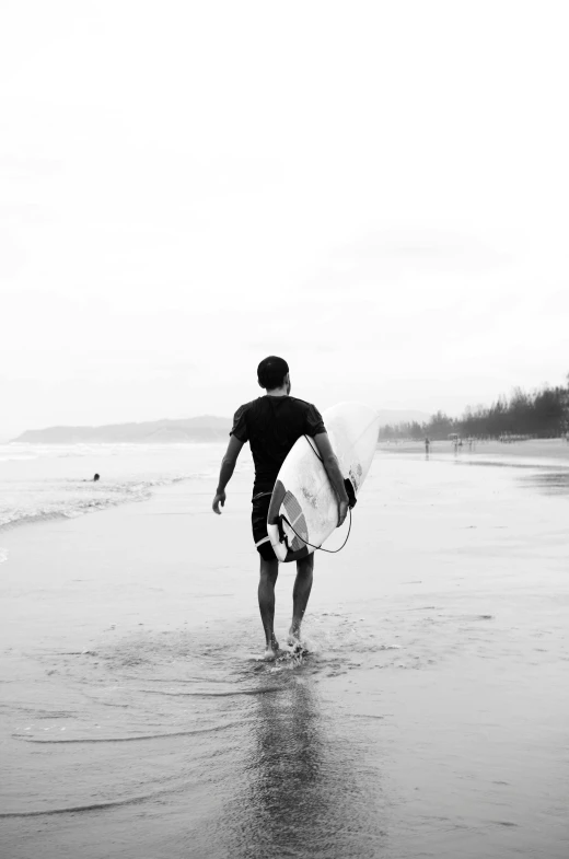 a black and white photo of a man holding a surfboard, unsplash contest winner, walking to the right, instagram post, white water, beaches