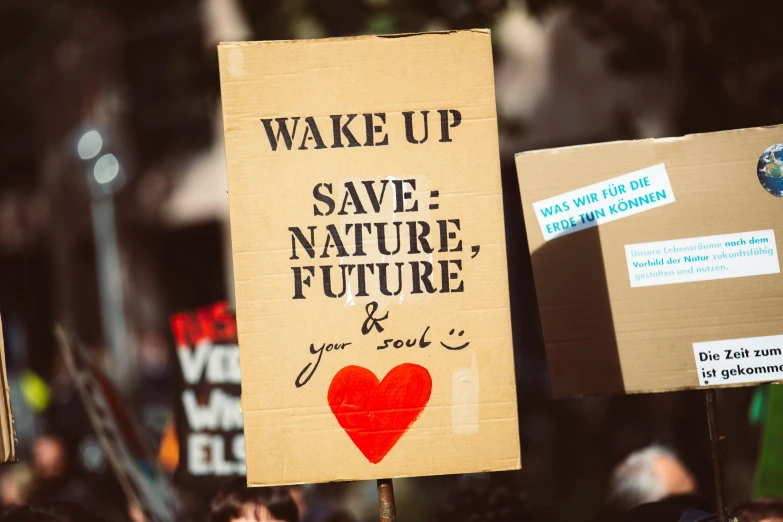 a sign that says wake up save nature, future you love, by Julia Pishtar, trending on pexels, protest, cardboard, avatar image