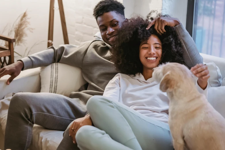 a man and woman sitting on a couch with a dog, essence, diverse, uploaded, carefree