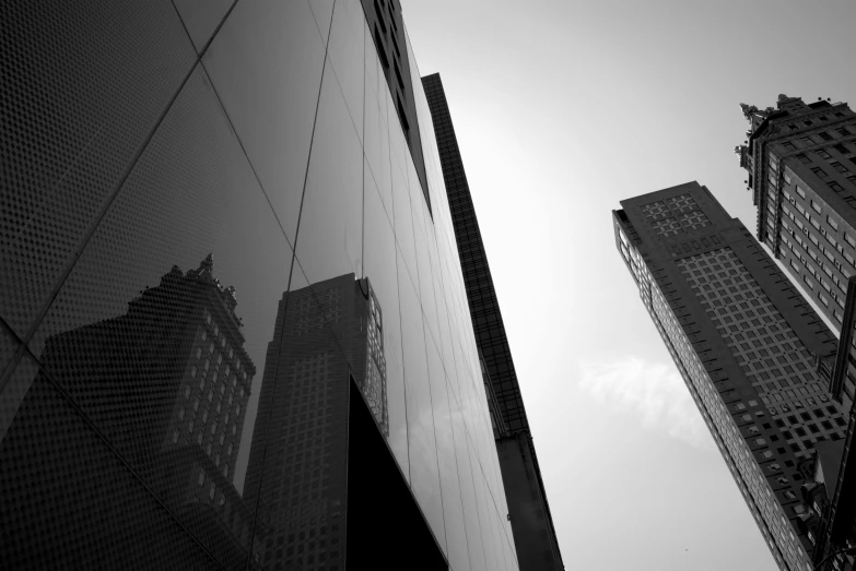 a black and white photo of some tall buildings, inspired by Cheng Jiasui, mirror and glass surfaces, beijing, in glass town, monoliths