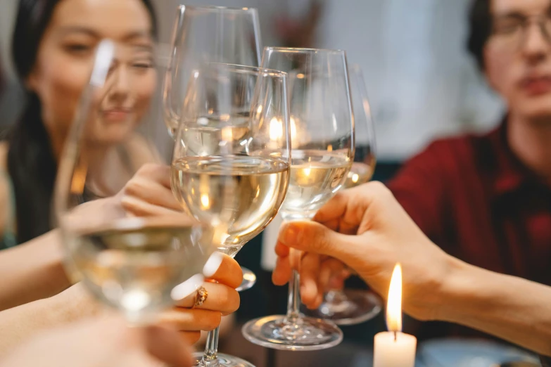 a group of people toasting with wine glasses, pexels contest winner, asian women, white candles, background image, amanda lilleston