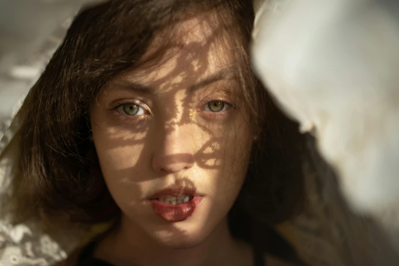 a close up of a person under a blanket, inspired by Elsa Bleda, pexels contest winner, photorealism, ana de armas portrait, sunny light, medium format. soft light, teenager girl