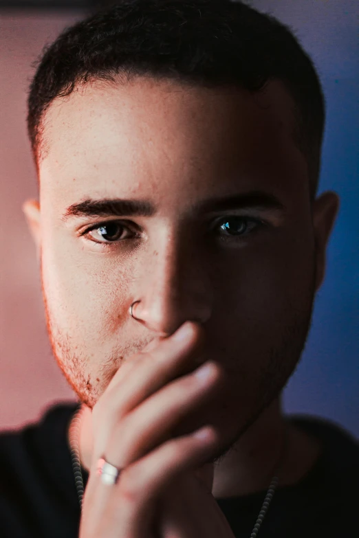 a man with a ring on his finger, a character portrait, inspired by Kyle Lambert, pexels contest winner, singer maluma, clean shaven wide face, bisexual lighting, teddy fresh