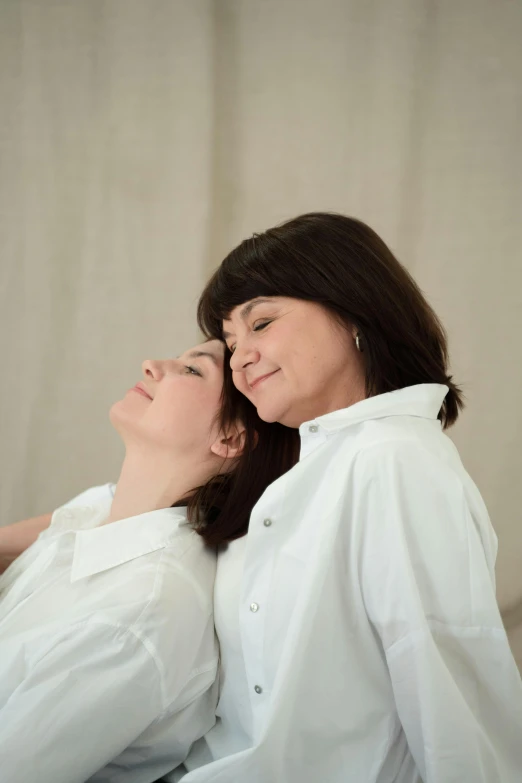 a couple of women sitting next to each other, by Marina Abramović, pexels contest winner, renaissance, wearing a white shirt, profile image, asleep, medical image