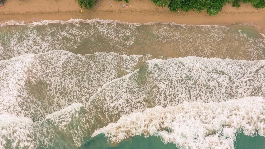 a large body of water next to a sandy beach, pexels contest winner, airborne view, towering waves, puerto rico, thumbnail