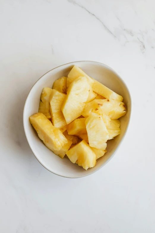 a white bowl filled with sliced pineapples, 6 pack, understated, 3 pm, editor's pickup