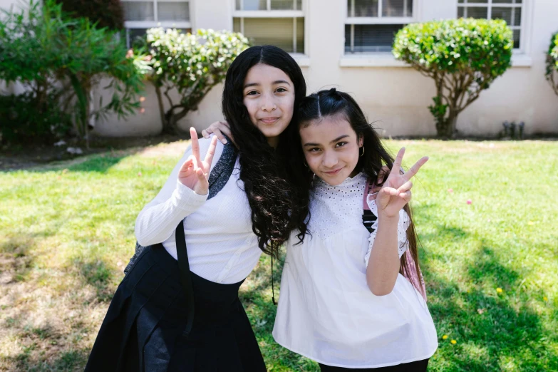 two girls posing for a picture in front of a house, pexels contest winner, ashcan school, peace sign, pale-skinned persian girl, with black pigtails, profile image