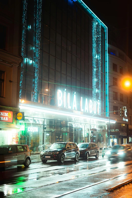 a city street filled with lots of traffic next to tall buildings, an album cover, by László Balogh, art nouveau, taken in night club, helsinki, thumbnail, exterior view