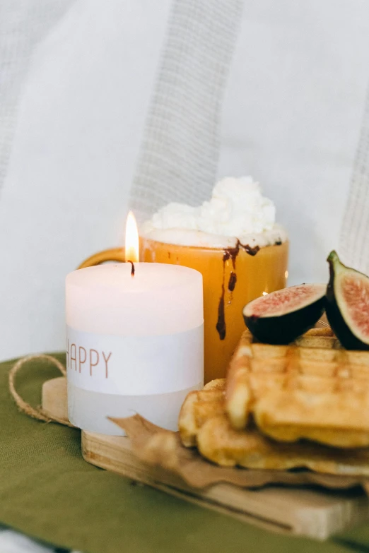 a plate topped with waffles next to a candle, a picture, trending on pexels, hurufiyya, happy smile, label, close-up product photo, candle dripping white wax