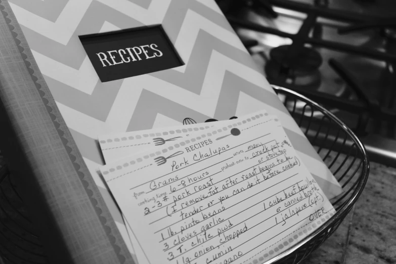 a black and white photo of a recipe book, by Caroline Mytinger, pexels, cards, closeup!!!!!!, black and white zig zag floor, 1 6 x 1 6