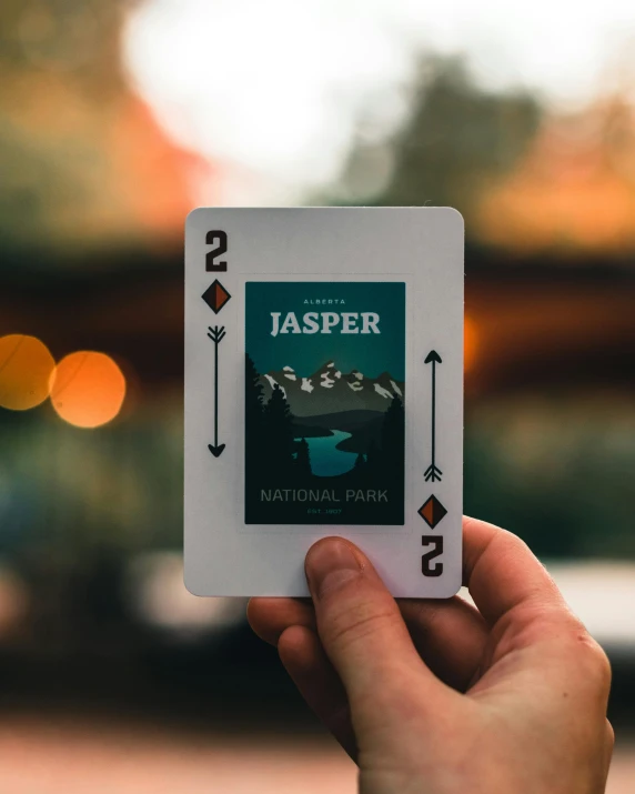 a person holding a playing card in their hand, inspired by Jesper Ejsing, unsplash contest winner, polaroid photo of trailerpark, to honor jupiter, vector behance hd jesper ejsing, high angle shot