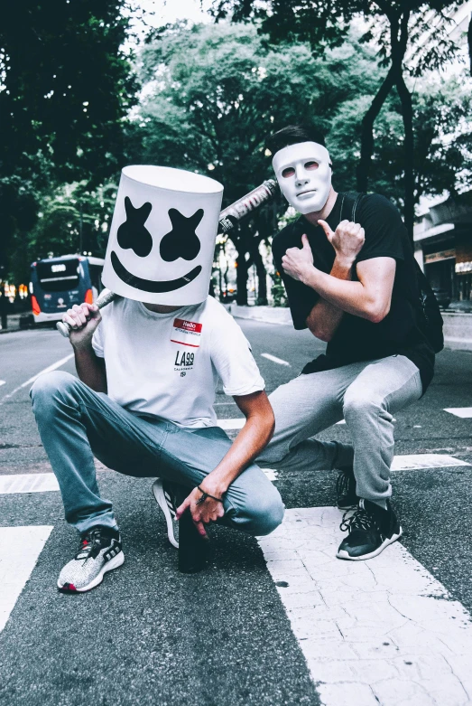 a couple of men standing next to each other on a street, an album cover, unsplash, white mask, edm fans, marshmallow, menacing pose