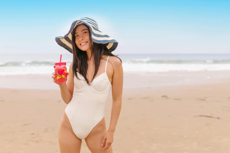 a woman standing on a beach holding a drink, pexels contest winner, plasticien, wearing a white bathing cap, gemma chan beautiful girl, avatar image, monokini