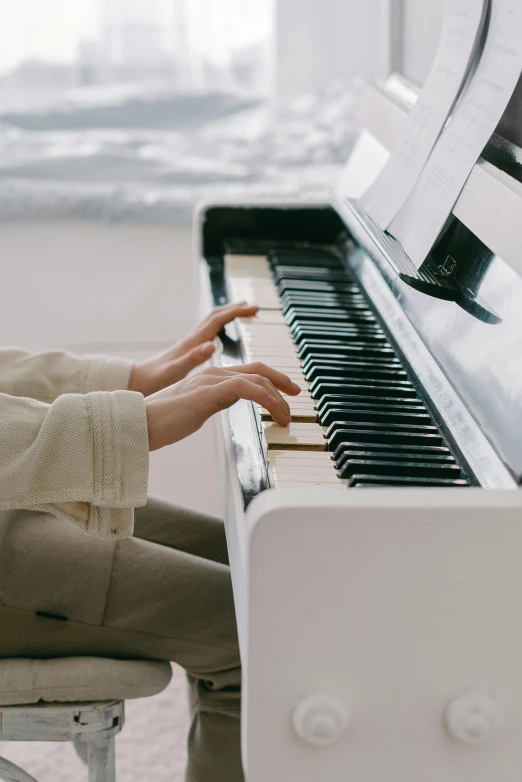 a close up of a person playing a piano, on the ocean, on a white table, premium, precious moments