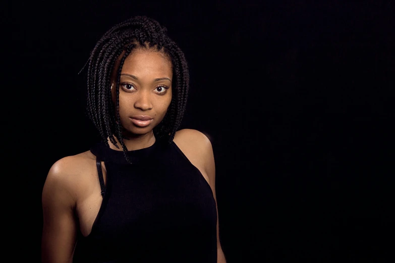 a woman in a black top posing for a picture, by Chinwe Chukwuogo-Roy, pexels contest winner, renaissance, dark. studio lighting, early 2 0 0 0 s, black hair in braids, medium format. soft light