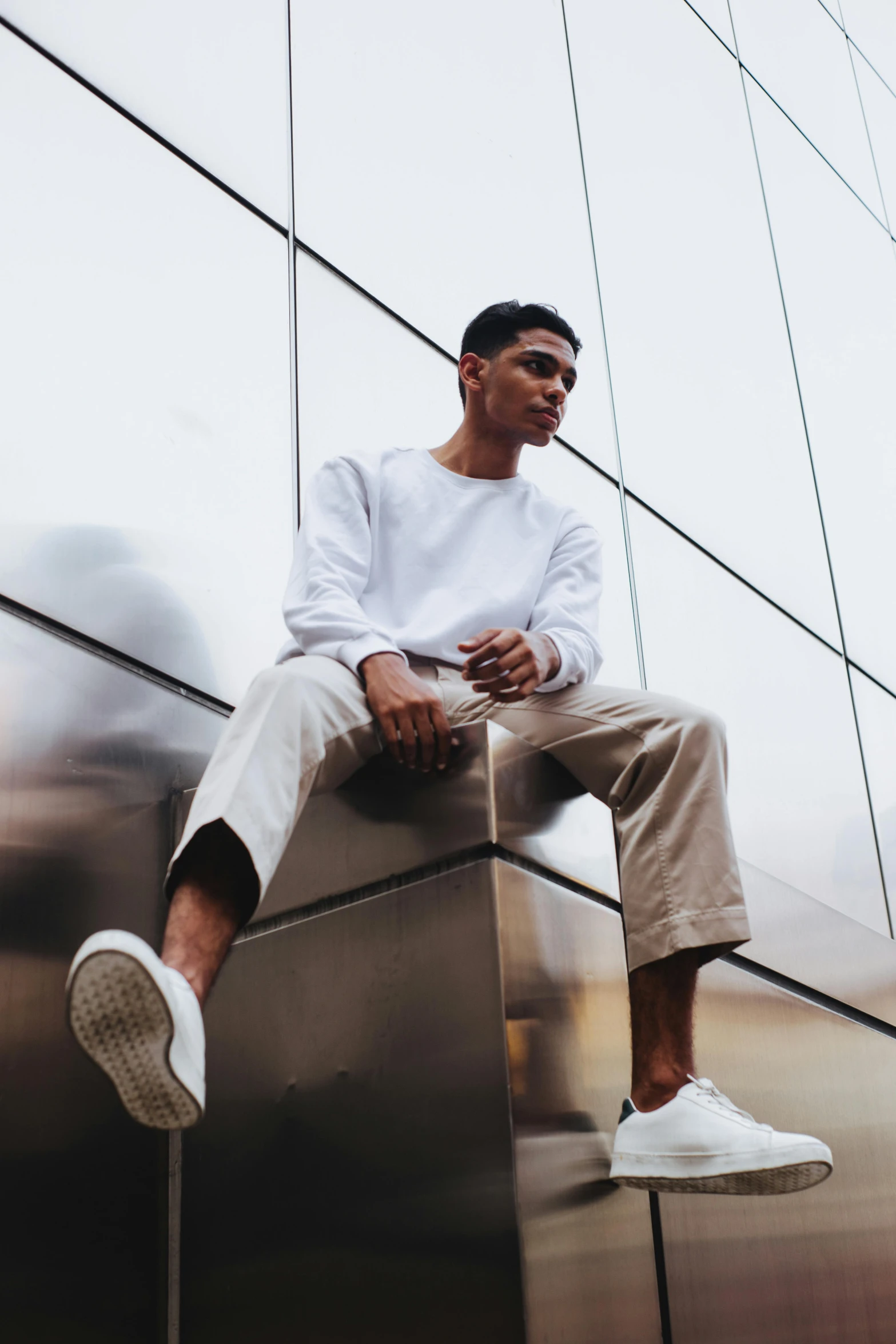 a man sitting on top of a metal block, pexels contest winner, wearing a white sweater, yzy gap, high soles, profile pic