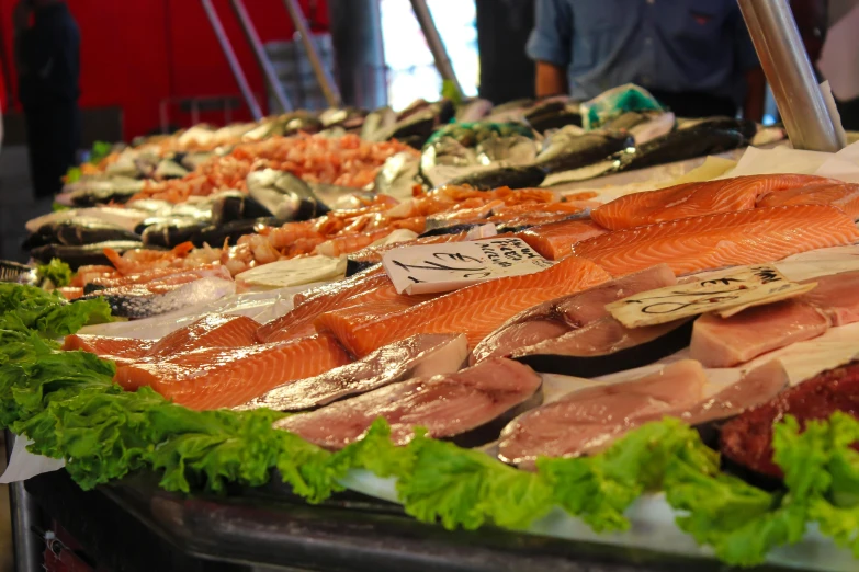 a table topped with lots of different types of fish, a photo, by Niko Henrichon, renaissance, square, thumbnail, shops, istockphoto