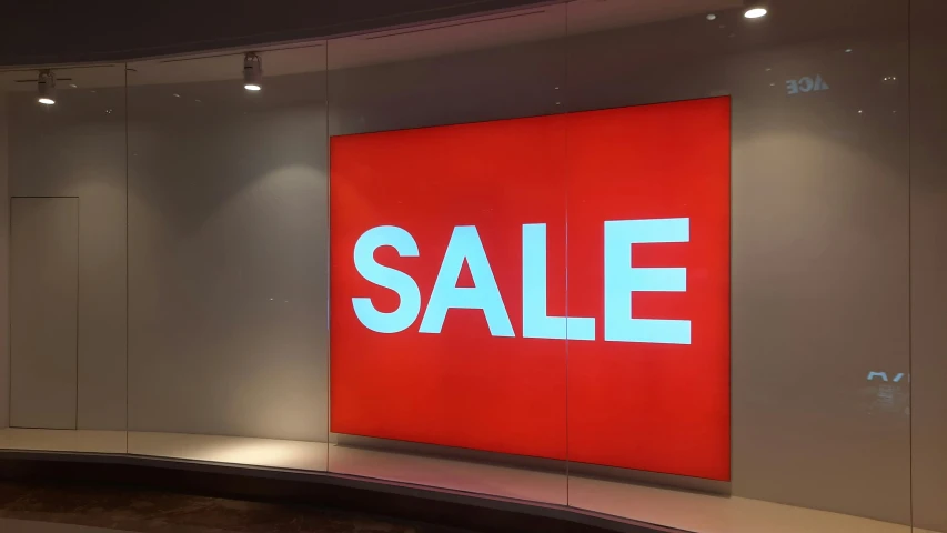 a red sale sign sitting on the side of a wall, a photo, hyperrealism, large led screens, glass wall, backlite, thumbnail