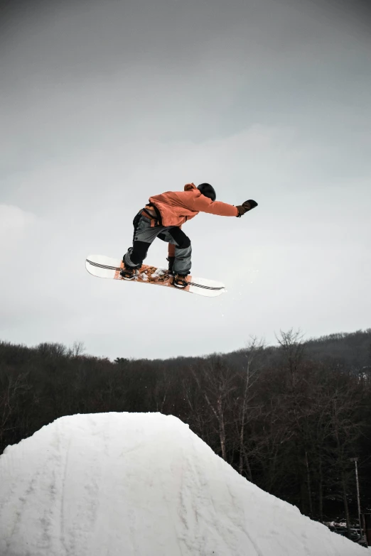 a man flying through the air while riding a snowboard, a colorized photo, by Alison Geissler, pexels contest winner, new hampshire, flawless structure, low quality photo, brown