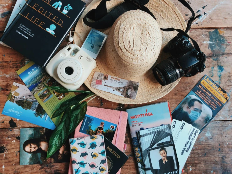 a straw hat sitting on top of a wooden table, a picture, pexels contest winner, happening, passport, flatlay book collection, avatar image, with a backpack