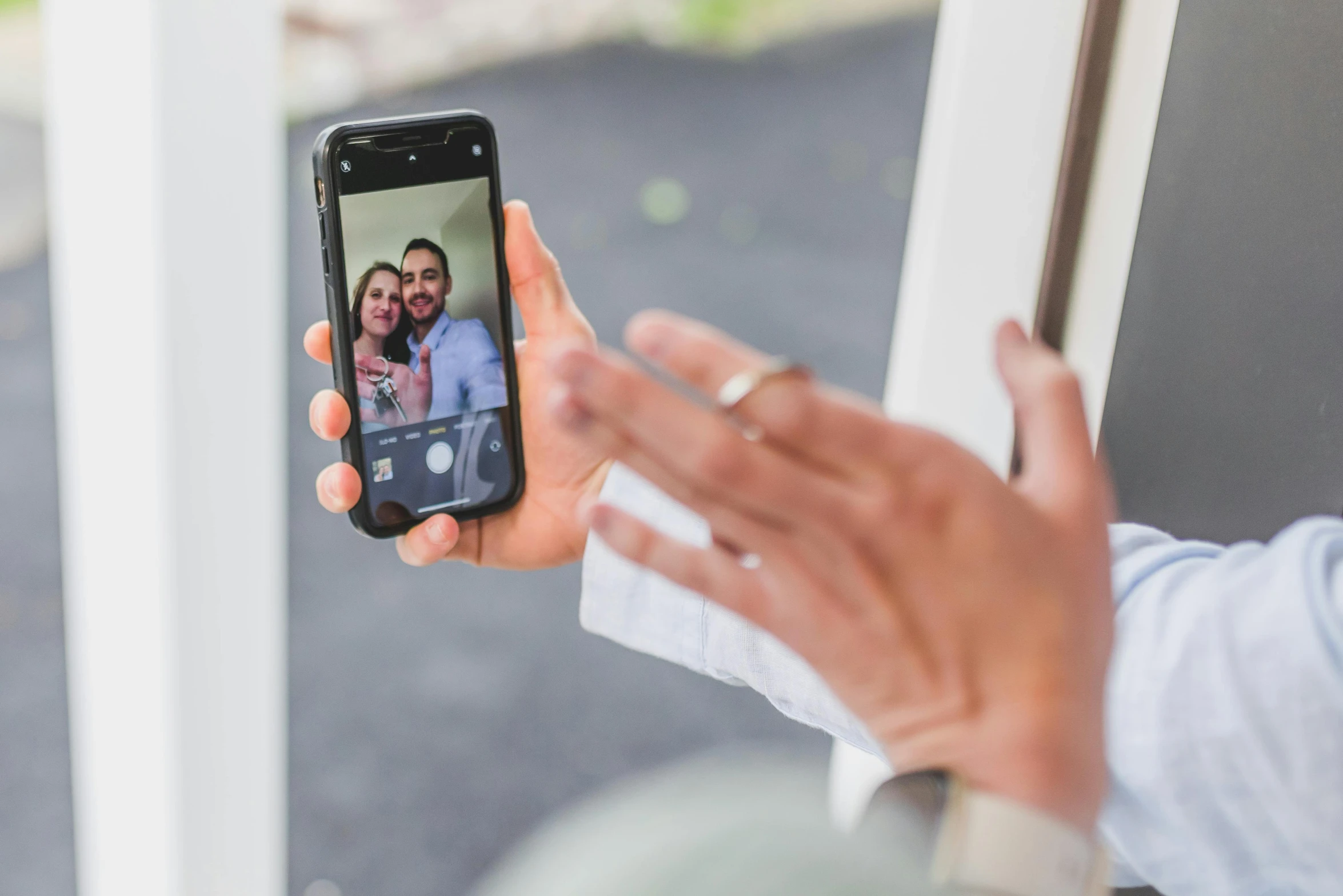 a close up of a person holding a cell phone, a picture, happening, about to enter doorframe, in love selfie, avatar image, threes