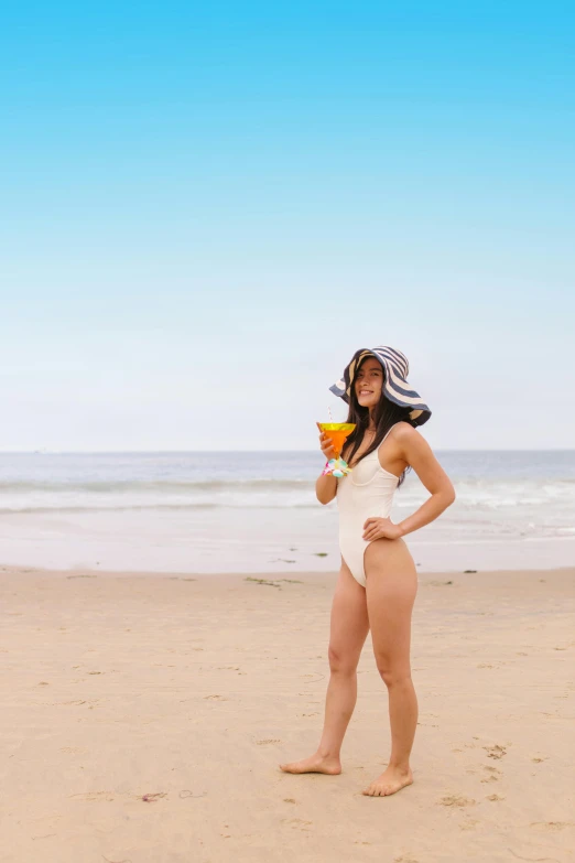 a woman standing on top of a sandy beach, holding a drink, profile image, monokini, shin min jeong