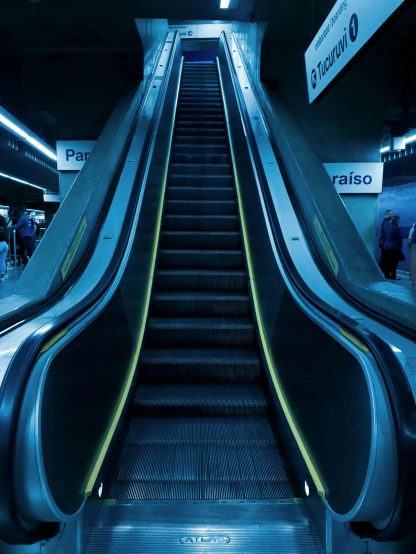 a close up of an escalator at a subway station, an album cover, inspired by Rodolfo Escalera, unsplash contest winner, hyperrealism, blue light accents, thumbnail, chile, dark. no text