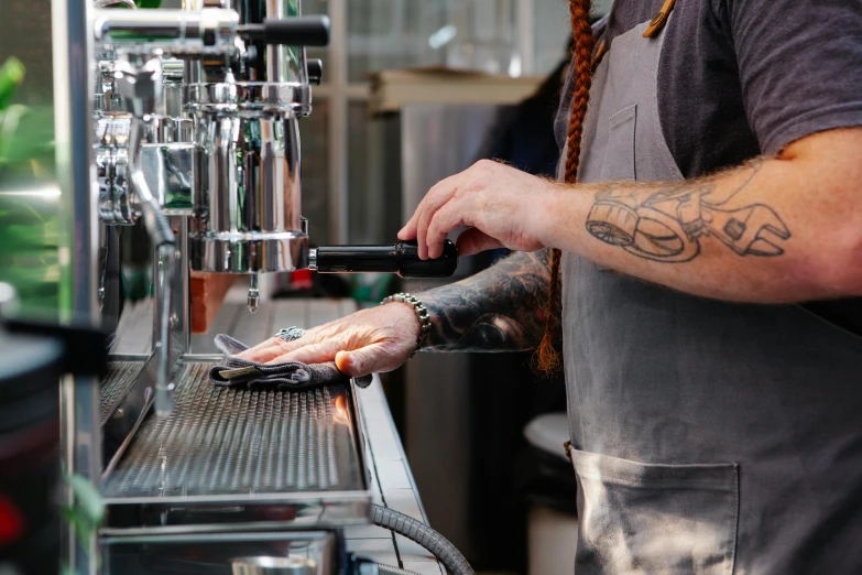 a man that is standing in front of a bar, coffee machine, sleek hands, amanda lilleston, some pouring techniques