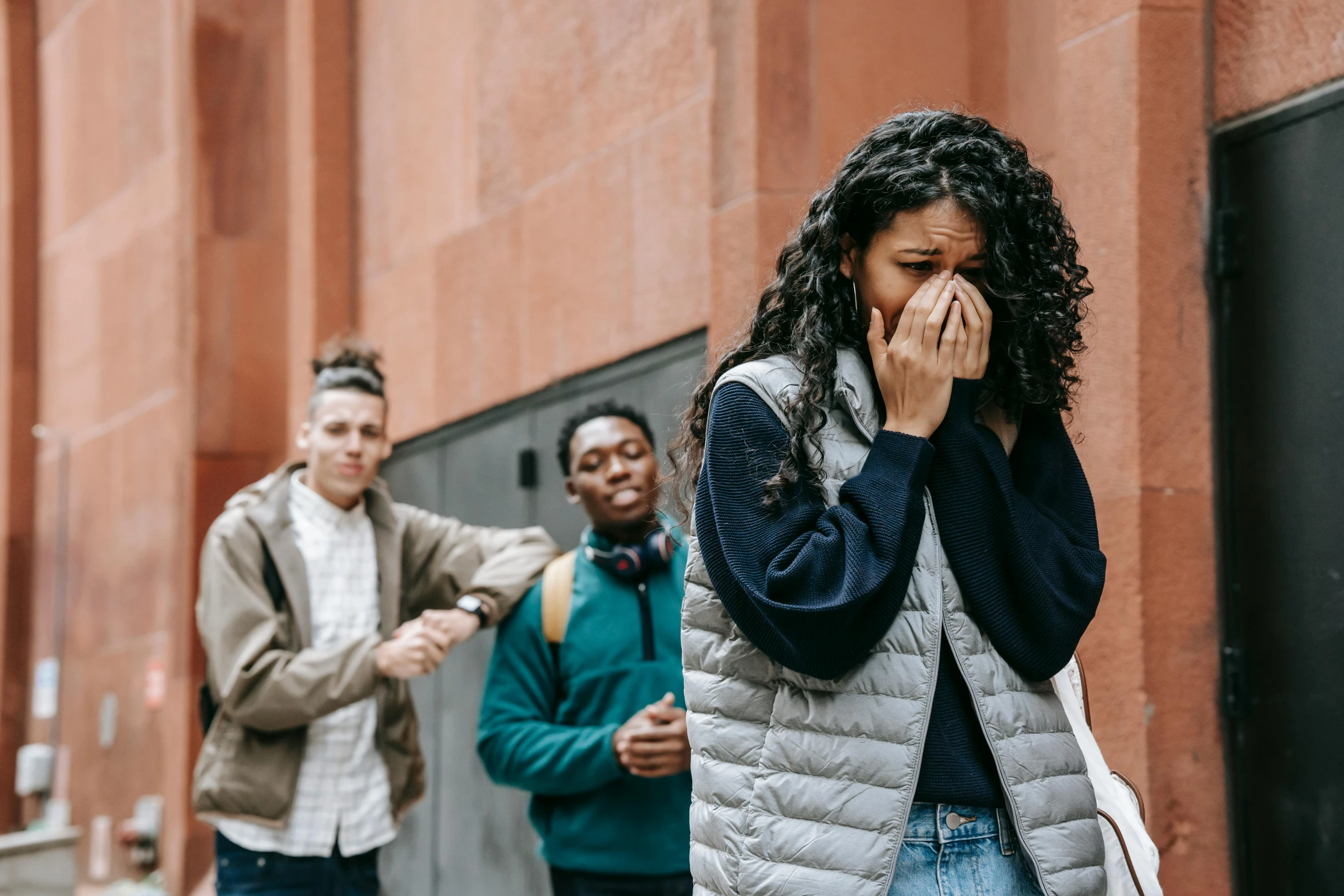 a group of people walking down a street, trending on pexels, renaissance, woman crying, high school, brown, facepalm