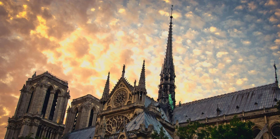 a very tall cathedral with a clock on it's side, pexels contest winner, art nouveau, sunset light, paris, brown, multicoloured